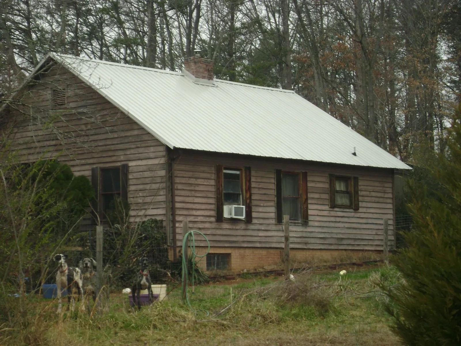 White metal roof on an old wood sided farmhouse, from a Metal Roof Installation job in Arcanum